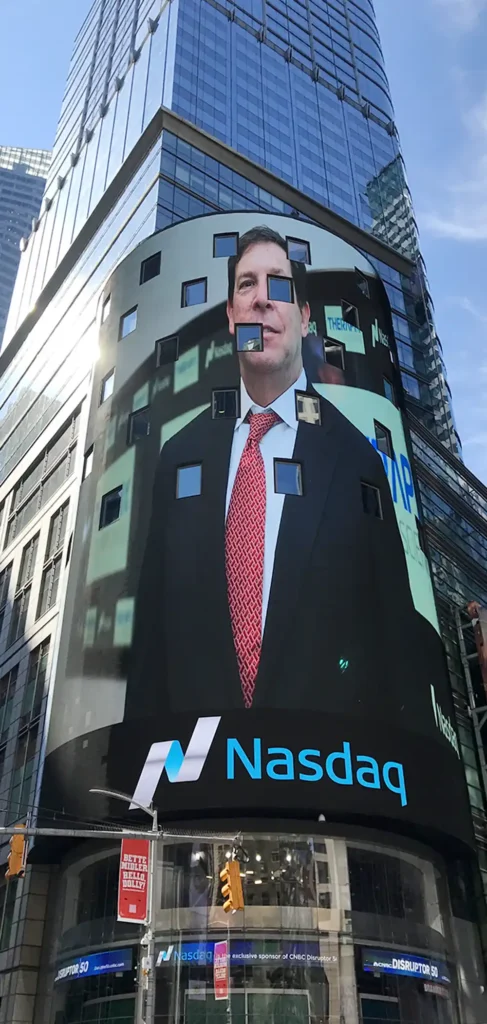 a photo of renowned attorney Harvey Kesner being displayed on the big screen on the Nasdaq building